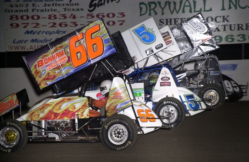 Nick Clinkenbeard (66), Gary Taylor (5*) and Matt Covington (95) lead the three-wide salute to the fans prior to Saturday night's 25-lap American Bank of Oklahoma ASCS Sooner Region feature at Cowtown Speedway.