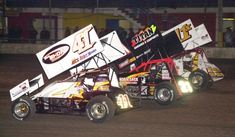 Jason Johnson (41), Daryn Pittman (21) and Garry Lee Maier (11x) lead the three-wide salute prior to Saturday night's 30-lap O'Reilly American Sprint Cars on Tour National feature event at Oklahoma City's State Fair Speedway.