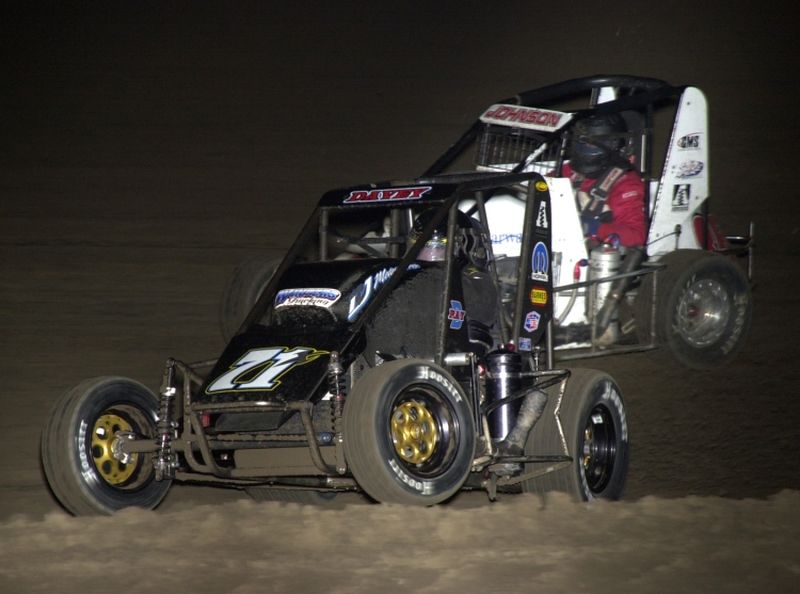 Davey Ray (71x) races underneath Matt Johnson in Monday night's Midget feature at the Butler County Motorplex.