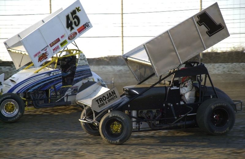 Sean McClelland, who went on to win Saturday night's American Bank of Oklahoma ASCS Sooner Region feature event at Creek County Speedway, battles with Kolt Walker (45k) in heat race action.