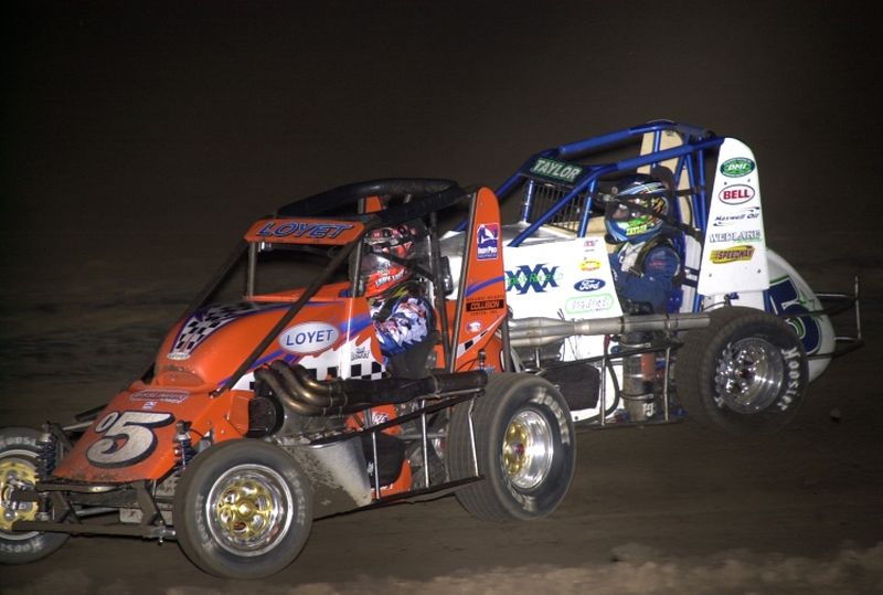 Brad Loyet (05) and Gary Taylor (5*) in Monday night's Kornhusker Midget Klassic feature at Rising City's Butler County Motorplex.