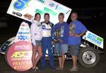 Gary Taylor and company enjoy American Bank of Oklahoma ASCS Sooner Region victory lane after topping a 41-car field in Saturday night's event at Cowtown Speedway in Kennedale, TX.