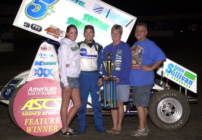 Gary Taylor and company enjoy American Bank of Oklahoma ASCS Sooner Region victory lane after topping a 41-car field in Saturday night's event at Cowtown Speedway in Kennedale, TX.